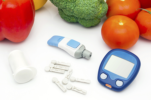glucometer material with vegetables in the back